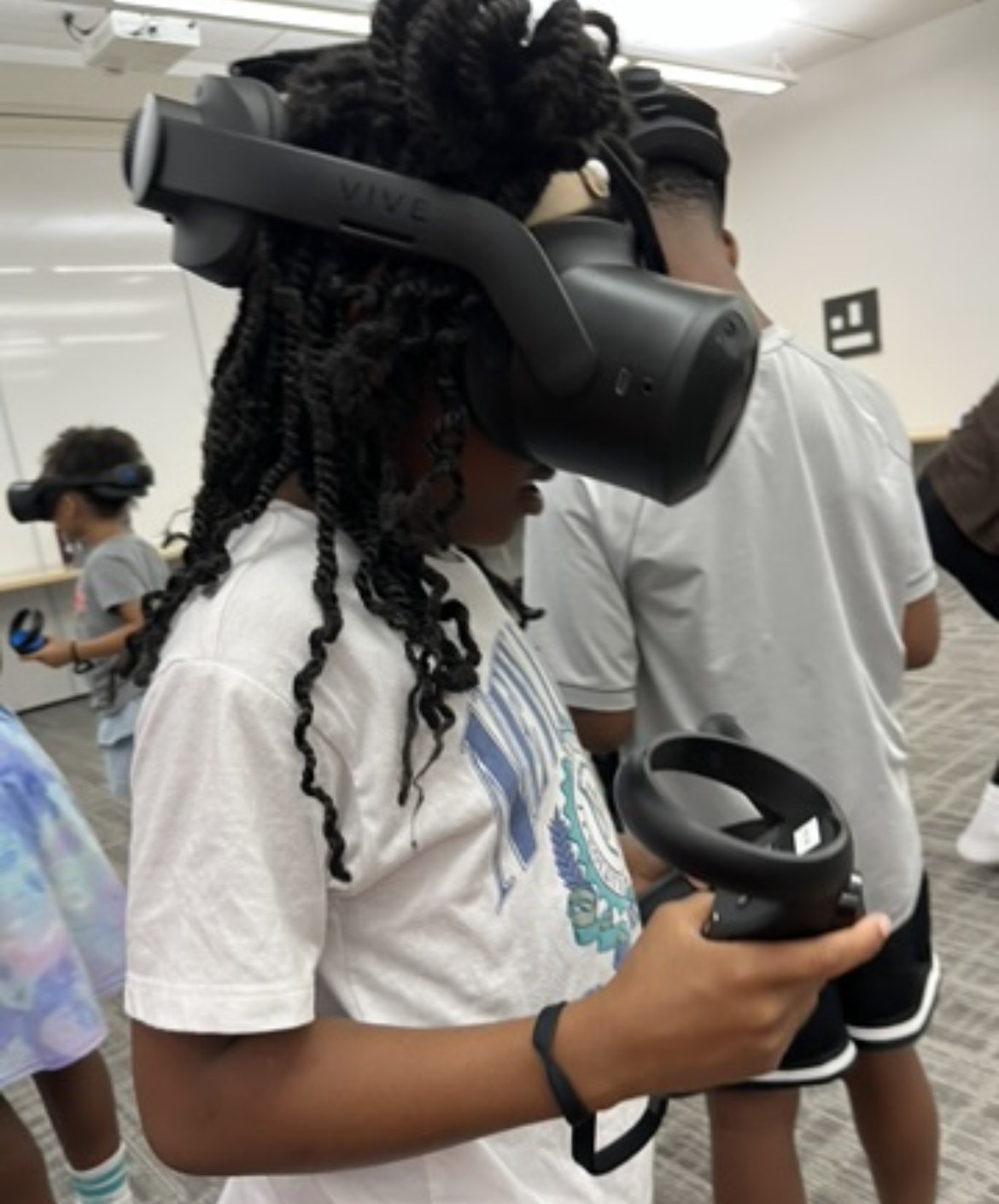 A student using a VR headset and controller