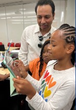 A mentor working with students on a project