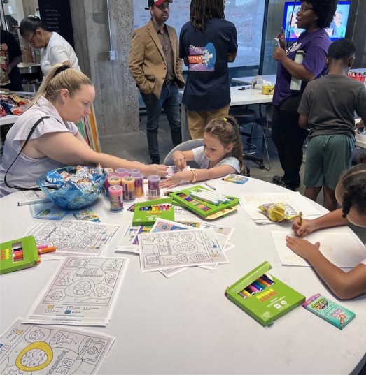 Families and children doing STEAM activities at a table